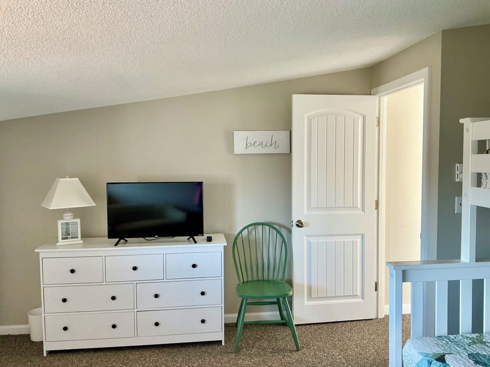 Third bedroom with dresser and TV