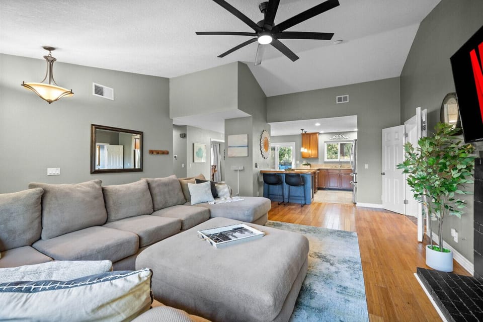 Open-concept living space with cozy seating, smart TV, and easy flow to the kitchen and dining.