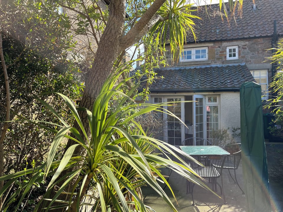 Sunny private garden with table and 4 chairs