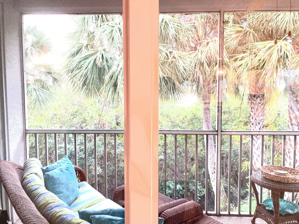 Privacy + bliss w/big rattan plush sofa and chairs. Lime green/aqua. Palm trees