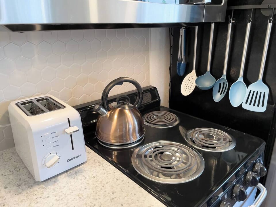 The kitchen is small but stocked with utensils, pots, pans, and other basics.