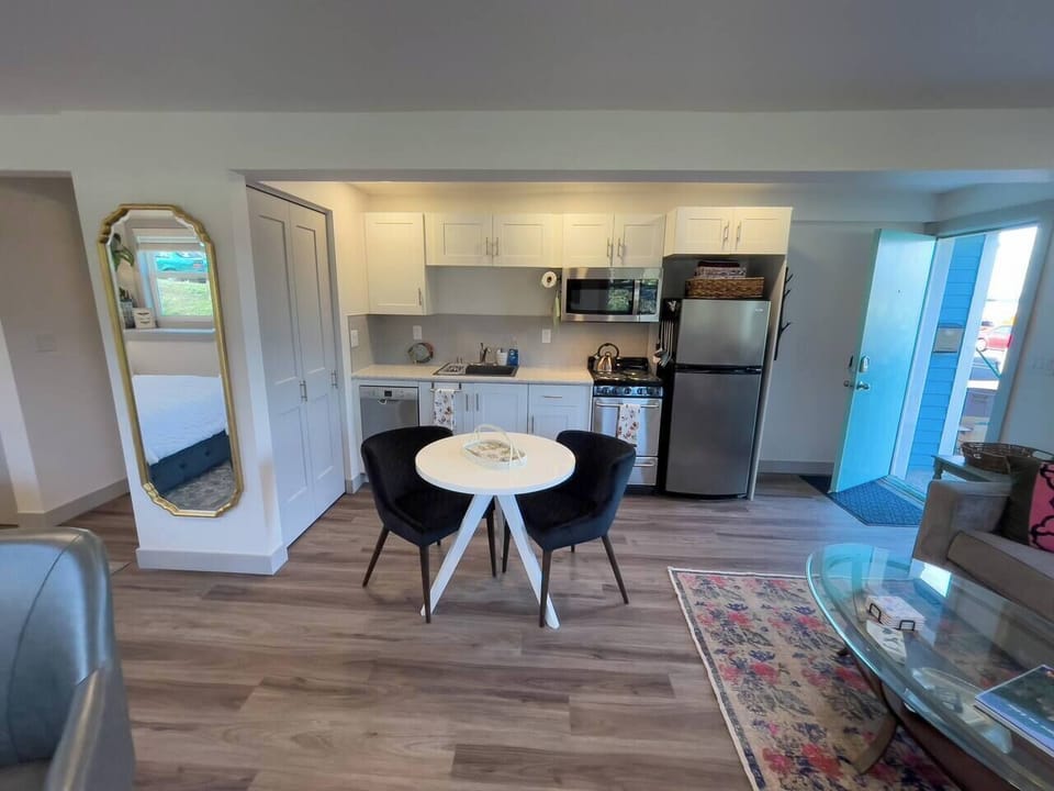 The kitchen table has room for two to eat, or can be used as a workspace to supplement the desk. Full-length mirror too. 