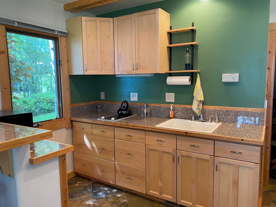 Kitchenette with microwave, 2 burner stove, coffee maker. 