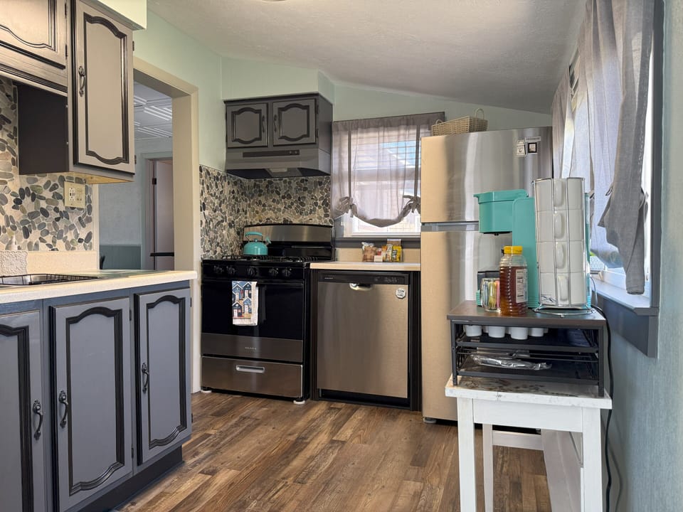 Kitchen with dishwasher, stove, fridge, and all cookware 