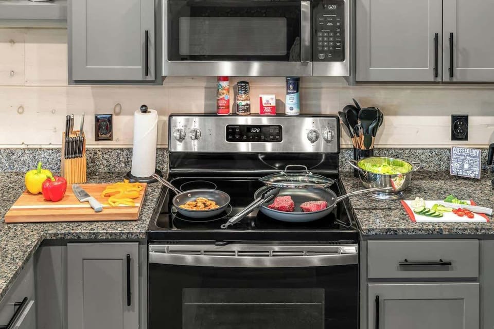 Whip up delicious meals with ease in this fully stocked kitchen, complete with quality cookware, utensils, cutting boards, and modern appliances. Everything you need is ready for your next home-cooked adventure.
