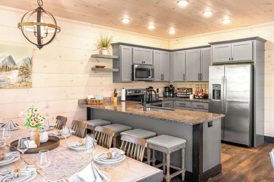 Gather, cook, and connect in this open-concept space featuring a dining table for 10, additional island seating, and a fully stocked kitchen — perfect for group meals, celebrations, and making memories together.
