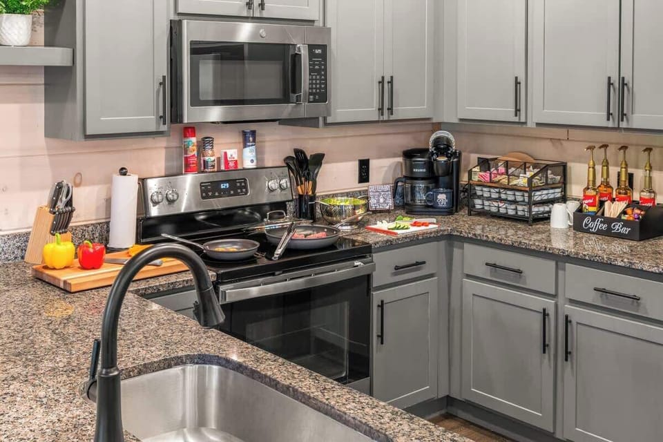 From meal prep to morning brews, this fully stocked kitchen features modern stainless steel appliances, quality cookware, and a dedicated coffee bar with syrups, pods, and creamers to kickstart your day in comfort.


