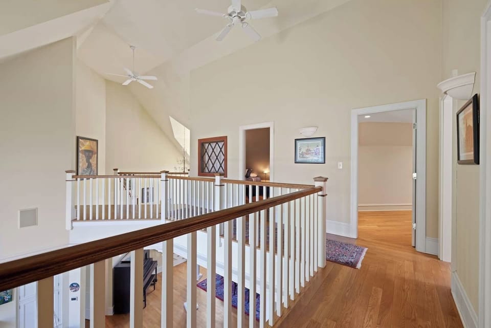Upstairs hallway overlooking the living room and river views.