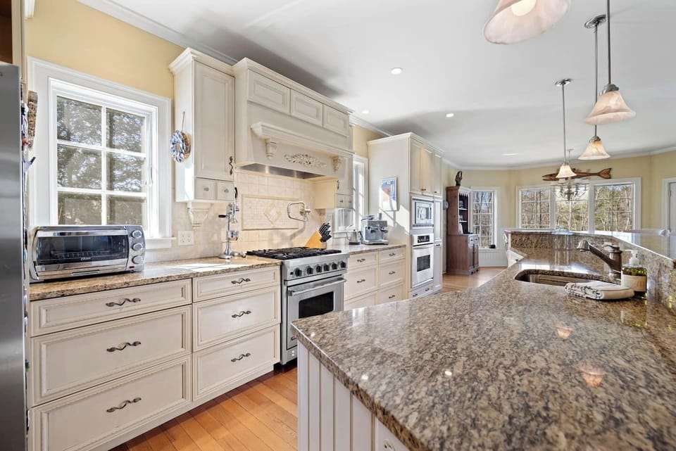 A kitchen made for a chef with a gas range and stocked to feed a crowd.