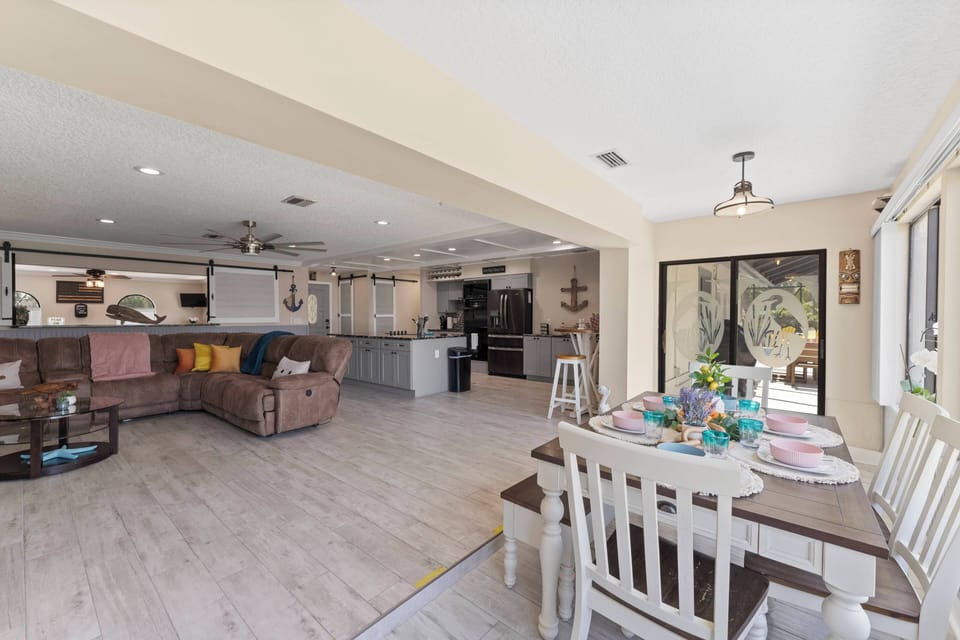 Living room to Dining room: Soft colors and comfy furniture invite you to unwind.