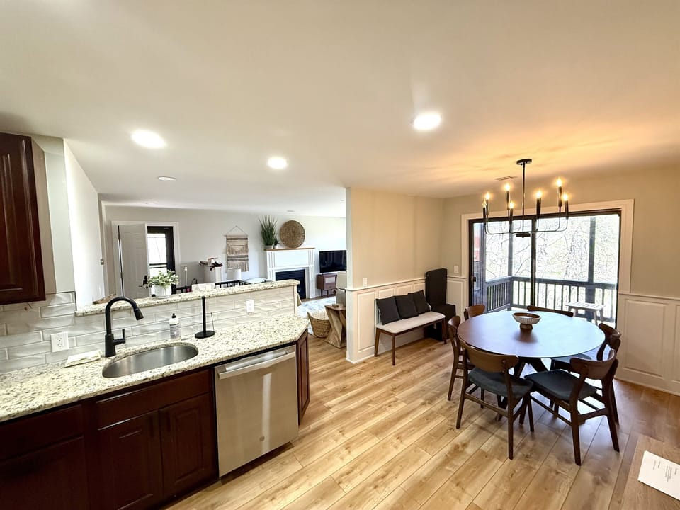 Enjoy the open-concept layout from the kitchen—flowing seamlessly into the living and dining areas, with a welcoming view of the front entry
