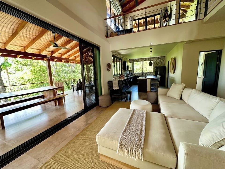 Second level common area with living room, kitchen, half bath, and veranda.