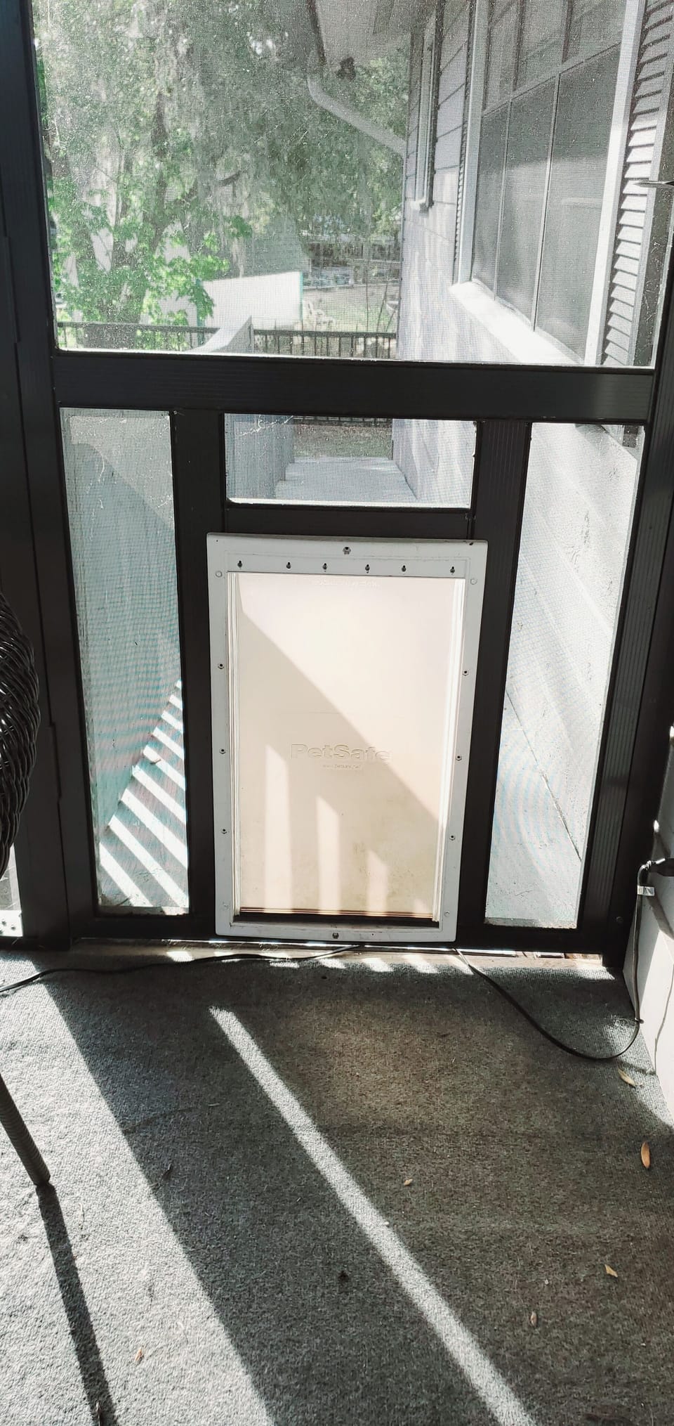 Extra large dog door from screened porch to ramp into fenced yard