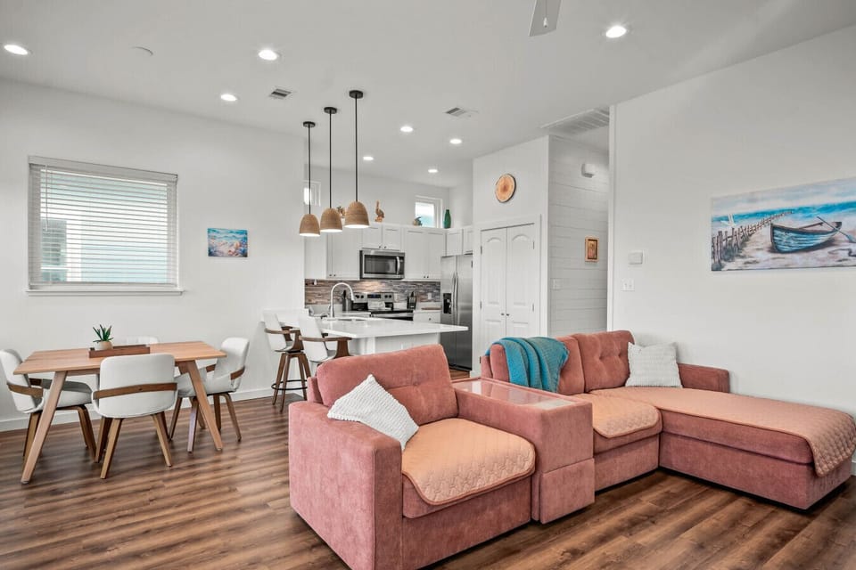 Cozy up in our bright beach-inspired living room — perfect for relaxing after a day in the sun.