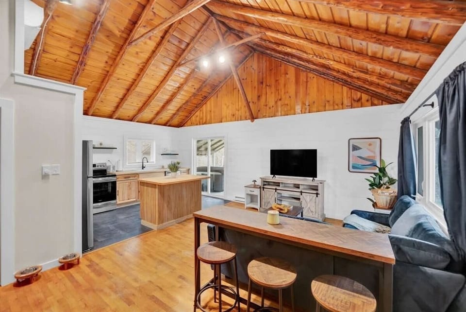 Open-Concept Living Room and Kitchen with Vaulted Wood Ceilings