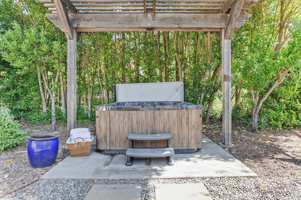 A stilled evening routine. Soak off the day in the private spa, set just off the patio and shaded by the trees.