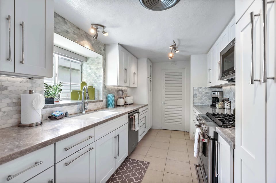 The airy kitchen offers ample space & all the comforts of home