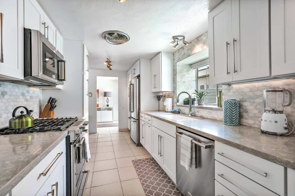 The airy kitchen offers ample space & all the comforts of home