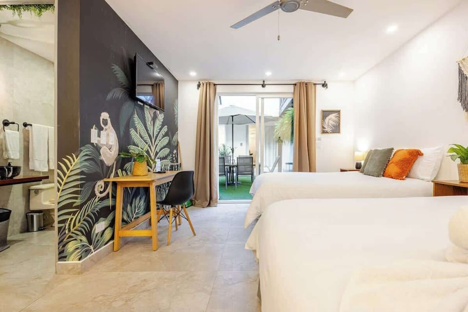 Studio 104 – First Floor
Designed for friends or siblings traveling together, this unit offers two queen beds in a shared, open layout. A blend of clean lines, soft textures, and modern lighting makes it both functional and welcoming.

