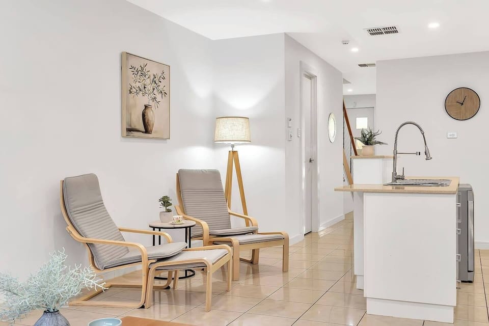 Tucked beside the main living area, this quiet corner with two armchairs is perfect for morning coffee or afternoon reading.