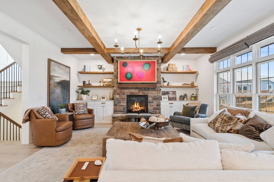 Stone fireplace, smart TV and cozy seating in this gorgeous living space.