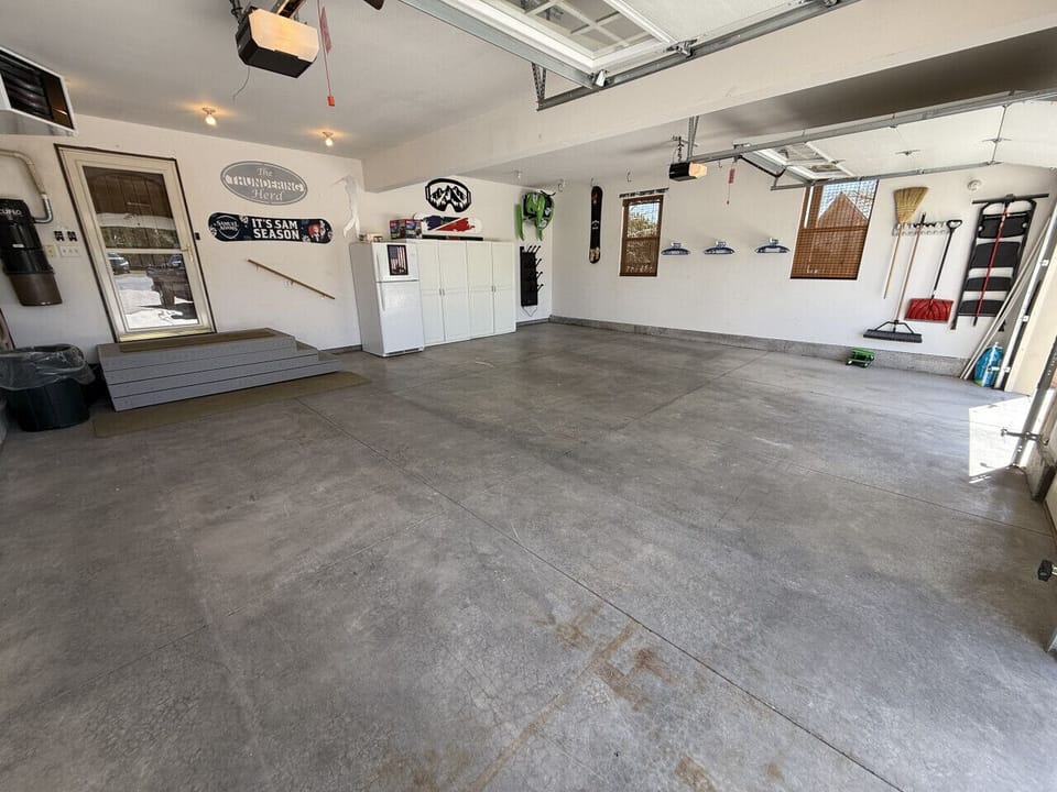 Heated garage with extra fridge, boot dryer, and hangers for snowmobile gear