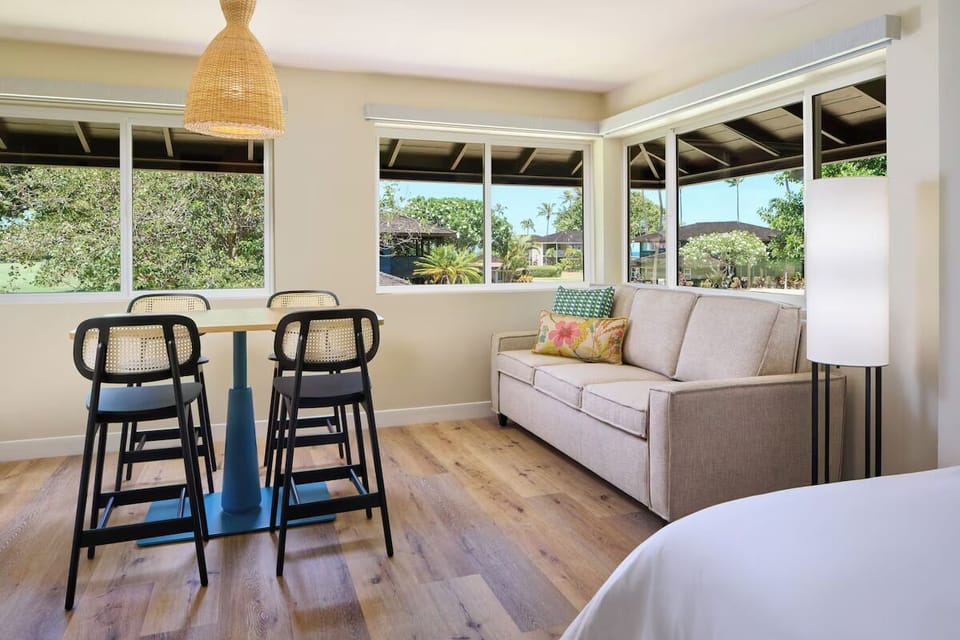 Lounge by wide windows and savor peaceful garden views.