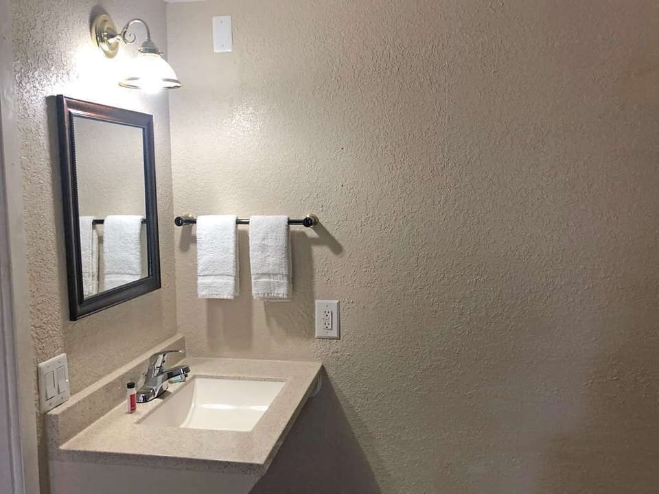Refresh at the bright vanity with clean towels within reach.