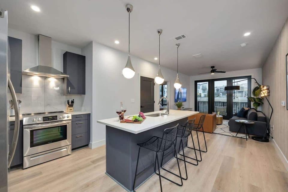 Unit 1: Fully equipped kitchen stocked with your basic cooking essentials. Includes stainless steel appliances, kitchen island, coffee machine, and toaster.