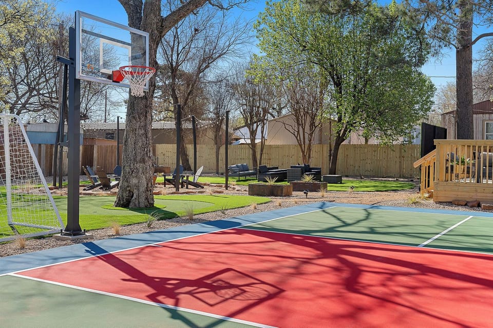 Private backyard sport court with basketball, soccer, and lounge space