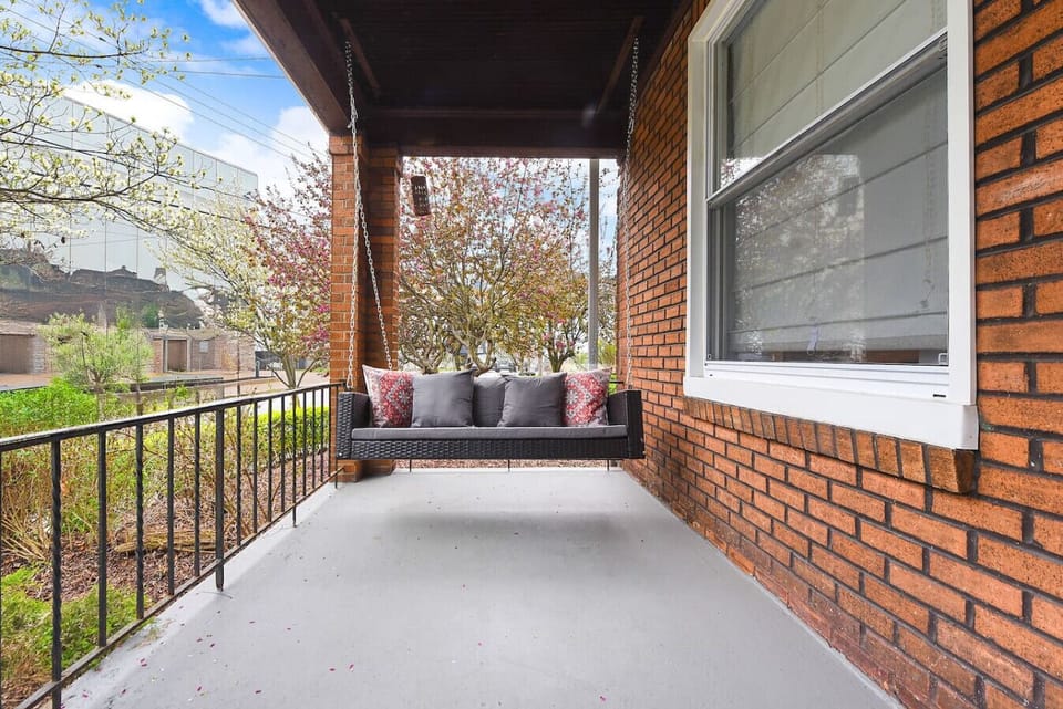 Enjoy peaceful moments on the porch swing, overlooking the serene surroundings and outdoor space.