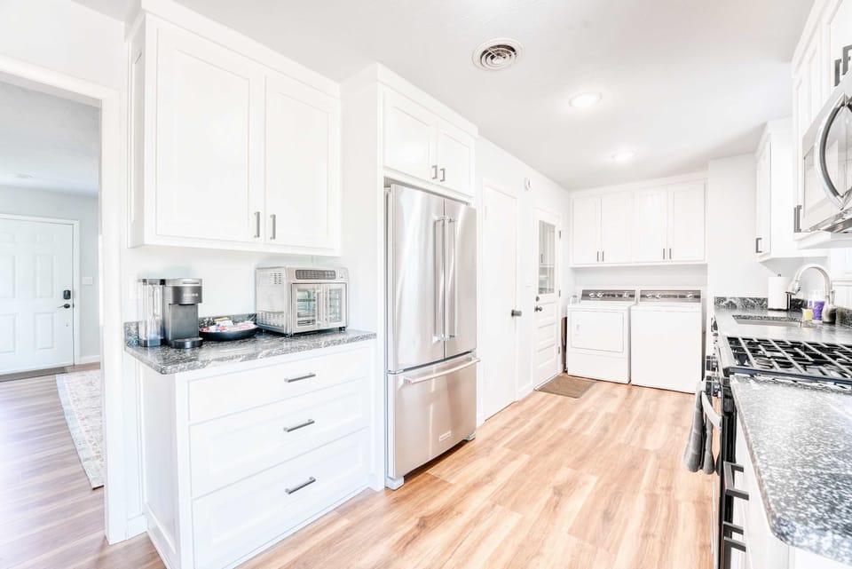 Bright kitchen with stainless appliances, granite counters and all the cookware you need to whip up hearty meals.