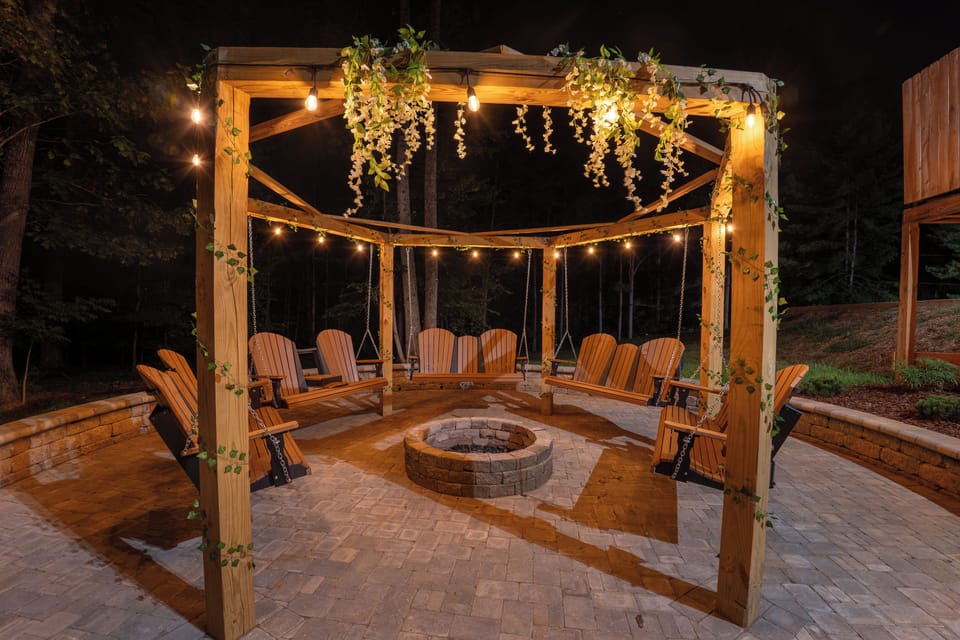 Settle into a swing beneath the lighted pergola and let the string lights glow over your fire pit patio. After a day on the lake or in the hot tub, this is where your group gathers, talks, and watches the stars come out.