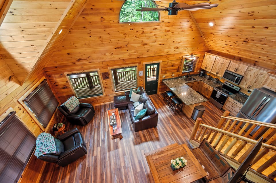 This incredible great room is the center around which all the fun begins for you and your family. Soaring 20’ high ceilings, unique natural stone, supple leather furniture, cozy nook and bespoke log tables.