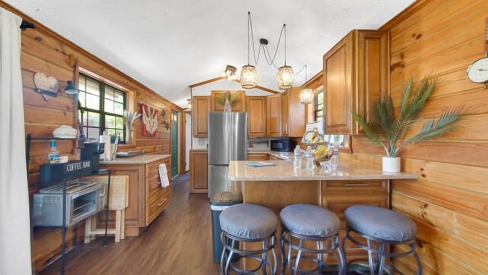 Kitchen with fridge, microwave, hot plate, and coffee maker.