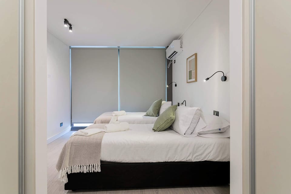 Designed for easy sharing. Our twin bedroom offers comfort and convenience for companions exploring Santiago.