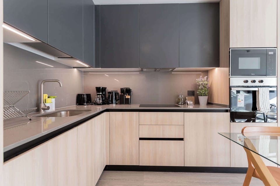 Experience culinary delights in this modern kitchen, featuring sleek cabinetry and top-notch appliances for your cooking adventures.