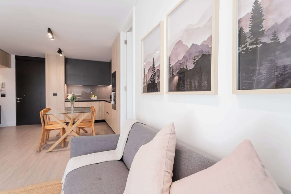 Experience modern comfort in this stylish living space, featuring a sleek kitchen and cozy seating, perfect for relaxing after a day of adventure.