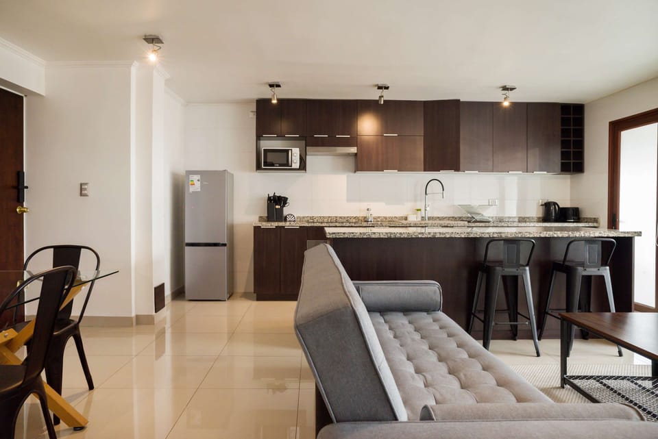Modern kitchen with sleek finishes and open layout, ideal for socializing and relaxation.