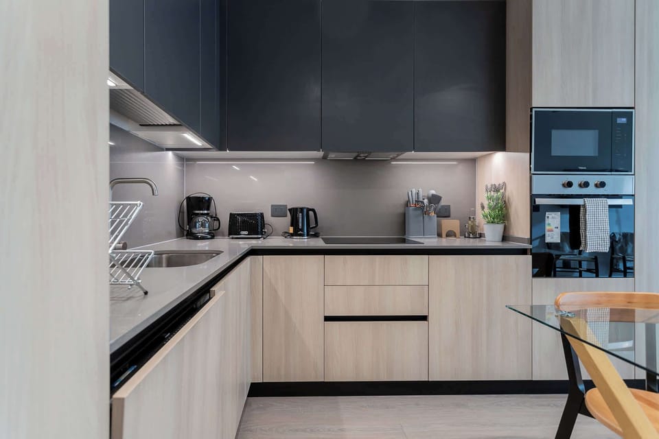 Experience culinary delights in this sleek, modern kitchen equipped with top-notch appliances and stylish finishes.