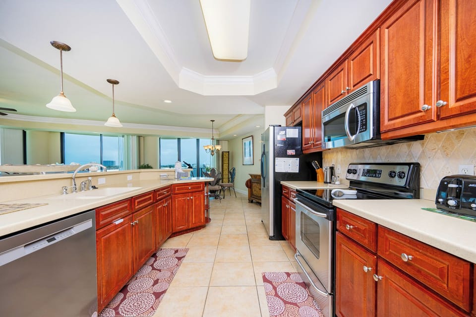 Prepare meals in this kitchen with elegant cabinetry, stainless appliances, and stylish backsplash