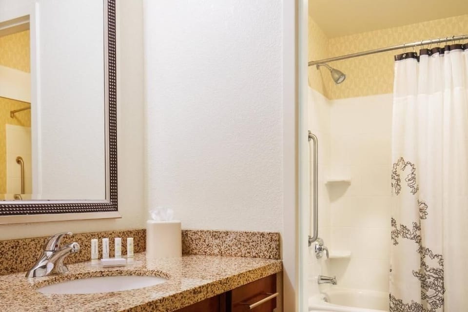 Get ready effortlessly with a granite vanity and well-lit mirror