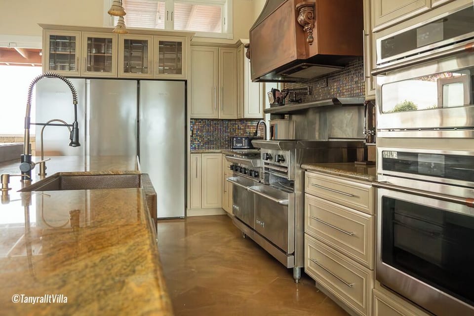 Kitchen with 3 ovens, 2 fridges, micro,  air fryer, dishwasher, beverage cooler