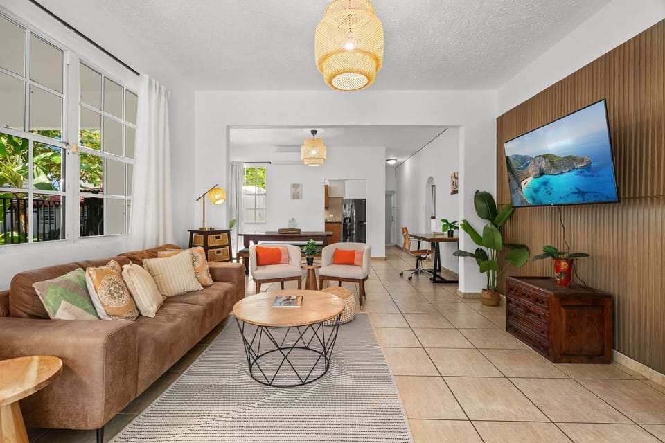 Spacious open-concept living area with smart TV and workspace