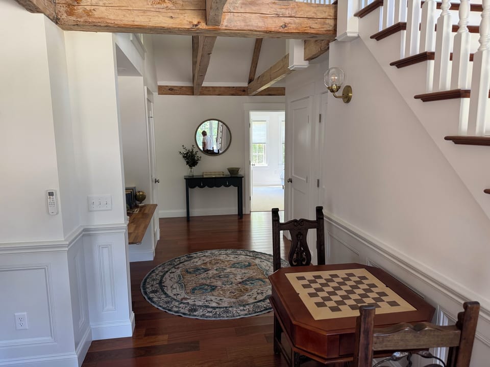 Updated hallway photo with Chess / Checkers table. Game closet under stairs 