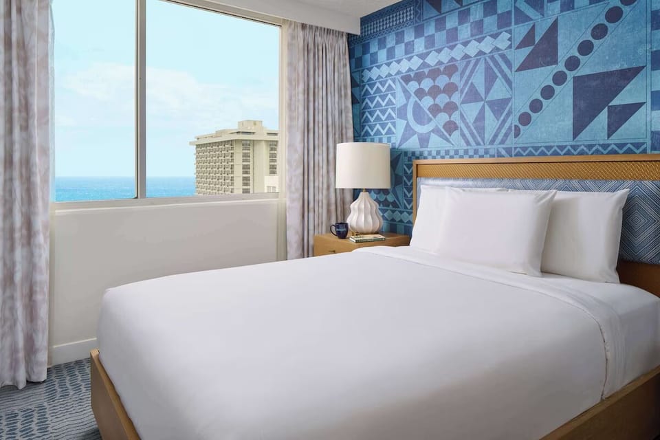 Drift off to ocean glimpses from crisp, cloud-soft bedding.