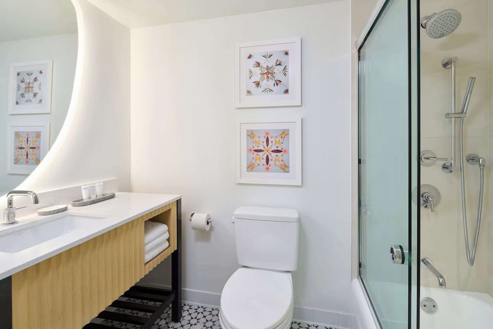 Refresh under a rain-style shower in a spotless bath.