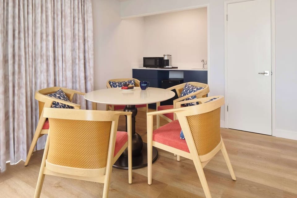 Gather for easy meals at the dining table beside kitchenette.