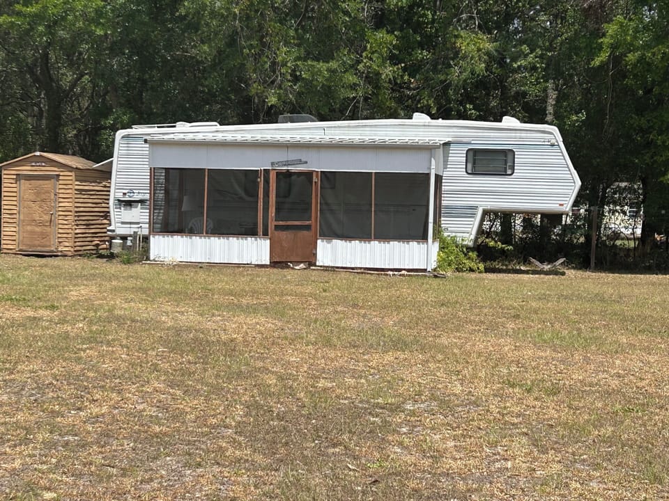 Comfortable Vintage 36’ RV for guests with screened patio