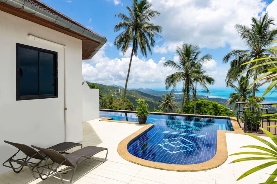 Private balcony with stunning sea views and tropical greenery at Sunview Paradise Village